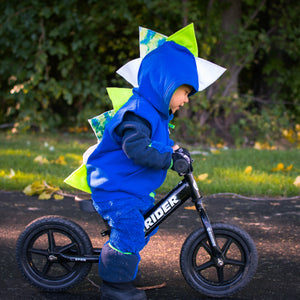 toddler-in-spike-hoodie-riding-bikes